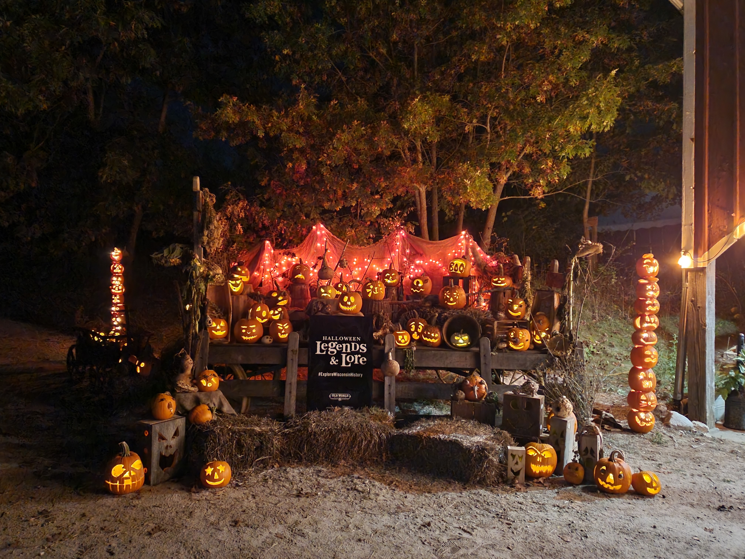 Jack o' lanterns set up on wooden pallets with a sign reading "Halloween Legends & Lore"